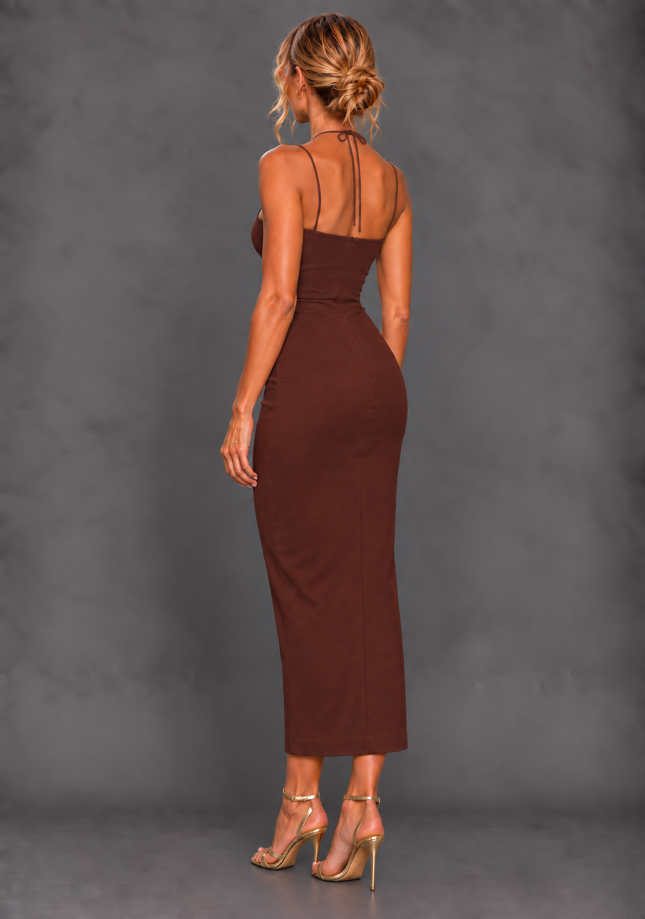 Side back image of a model wearing the VSPR Alyssa Strappy Chocolate Midaxi Dress, highlighting the smooth fitted silhouette and slender straps against a grey studio backdrop.