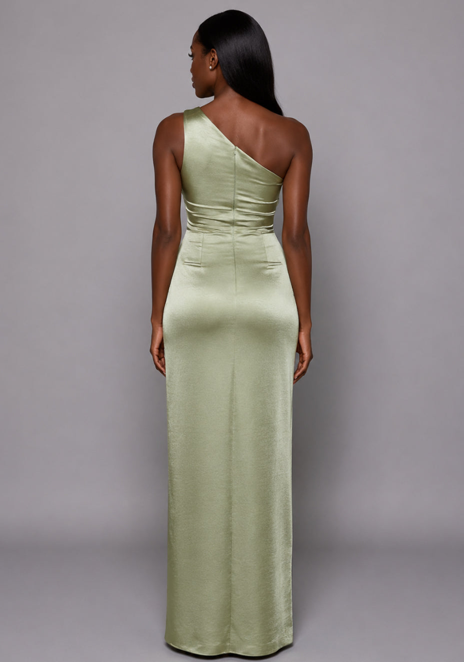 Back view of the VSPR Fliss One Shoulder Satin Olive Maxi Dress featuring a smooth fitted shape, maxi-length skirt, and lustrous olive satin fabric against a grey studio backdrop.
