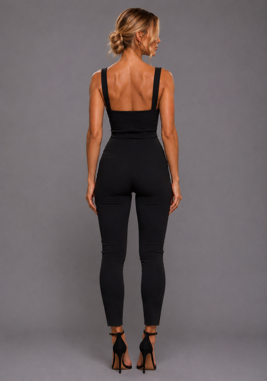 Back image of a model wearing the VSPR Juno Sweetheart Black Crop Top with wide straps and a structured cropped silhouette, paired with the VSPR Raven Slim Leg High Waisted Black Trousers, emphasising the elegant fit and timeless black design.