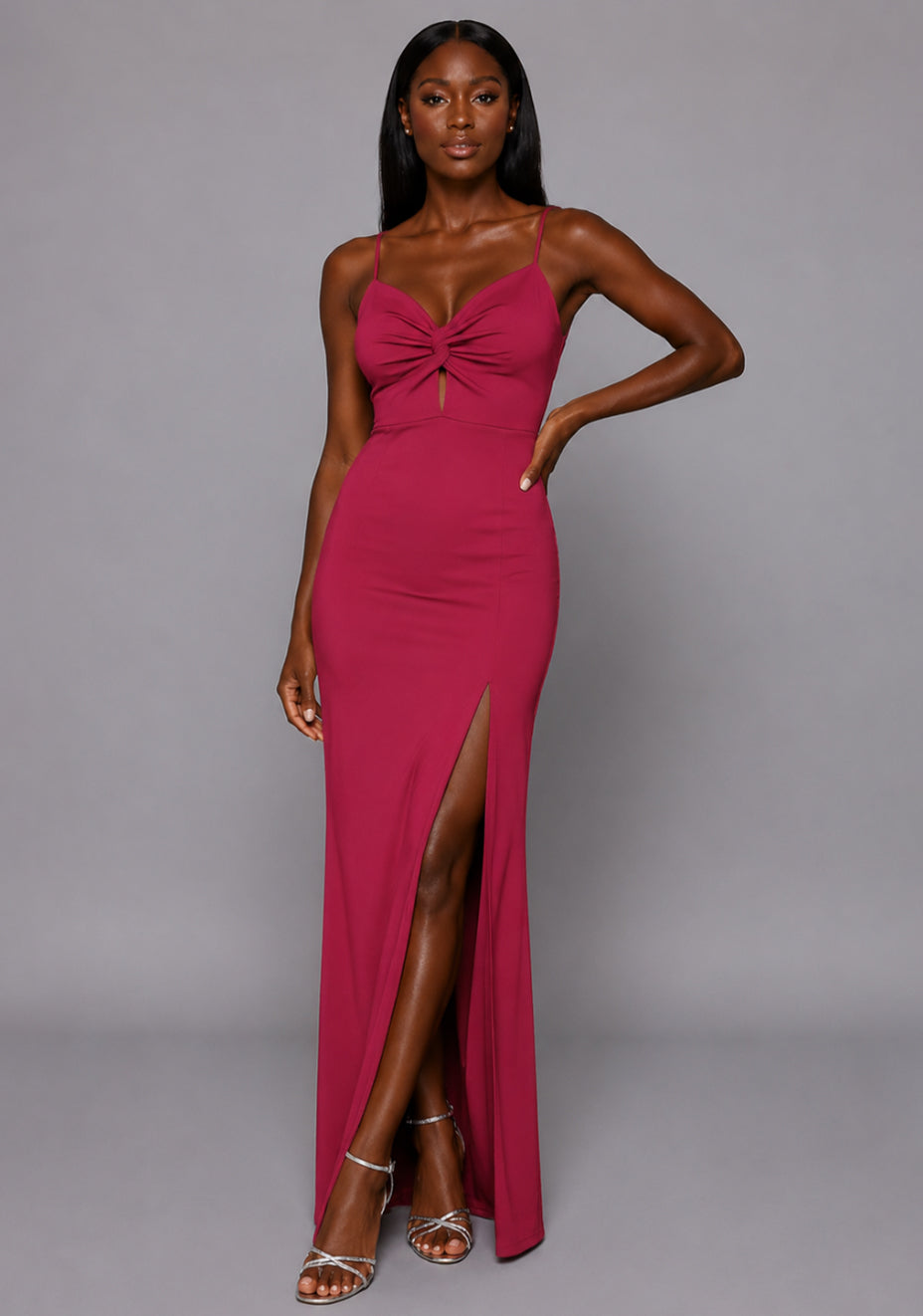 Front view of the VSPR Maggie Raspberry Maxi Dress featuring delicate thin straps, an elegant fitted bodice, and graceful floor-length design against a grey studio backdrop.