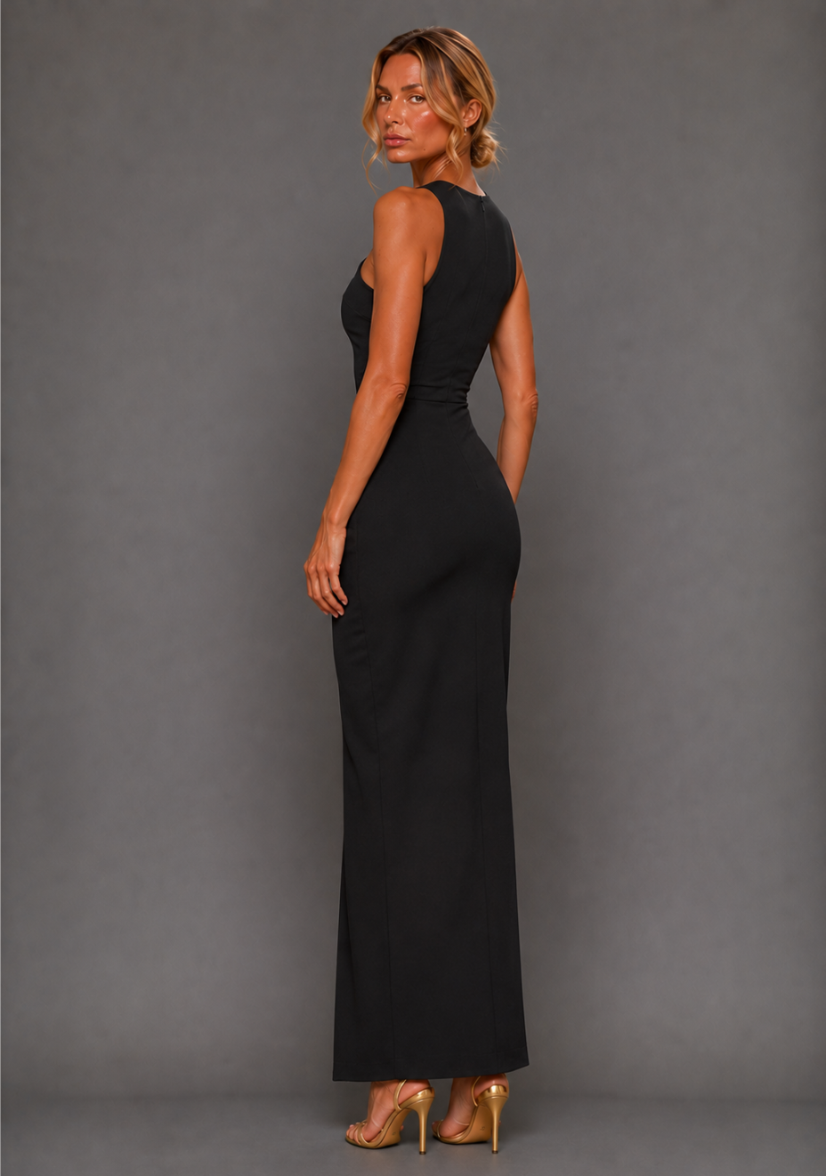Side front image of a model wearing the VSPR Polly Asymmetrical Maxi Dress in Black, showing the elegant drape and subtle movement of the front leg split.