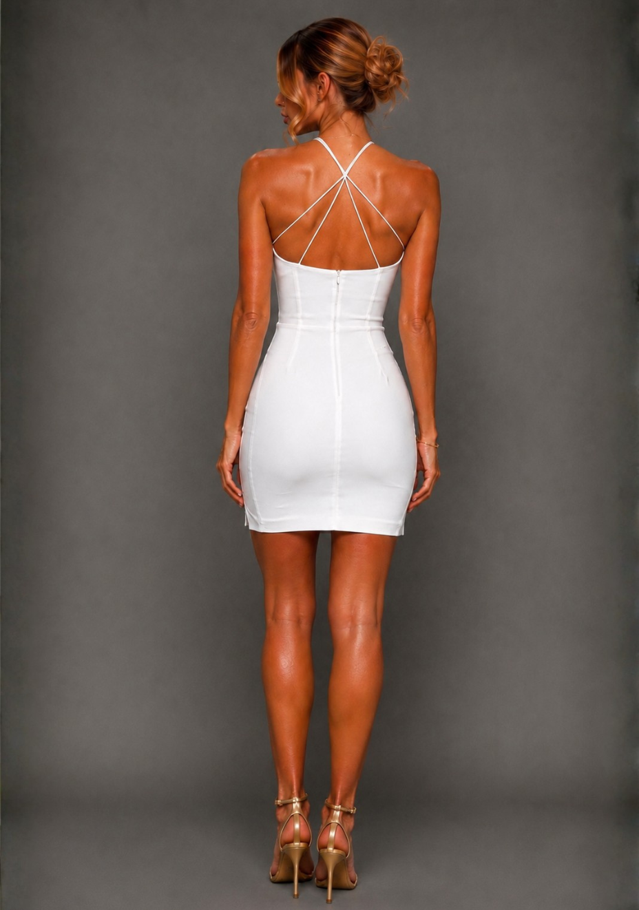 Back image of a model wearing the Vesper Rumi Back Strap Detail Ivory Mini Dress highlighting the crossover back straps and clean fitted silhouette.