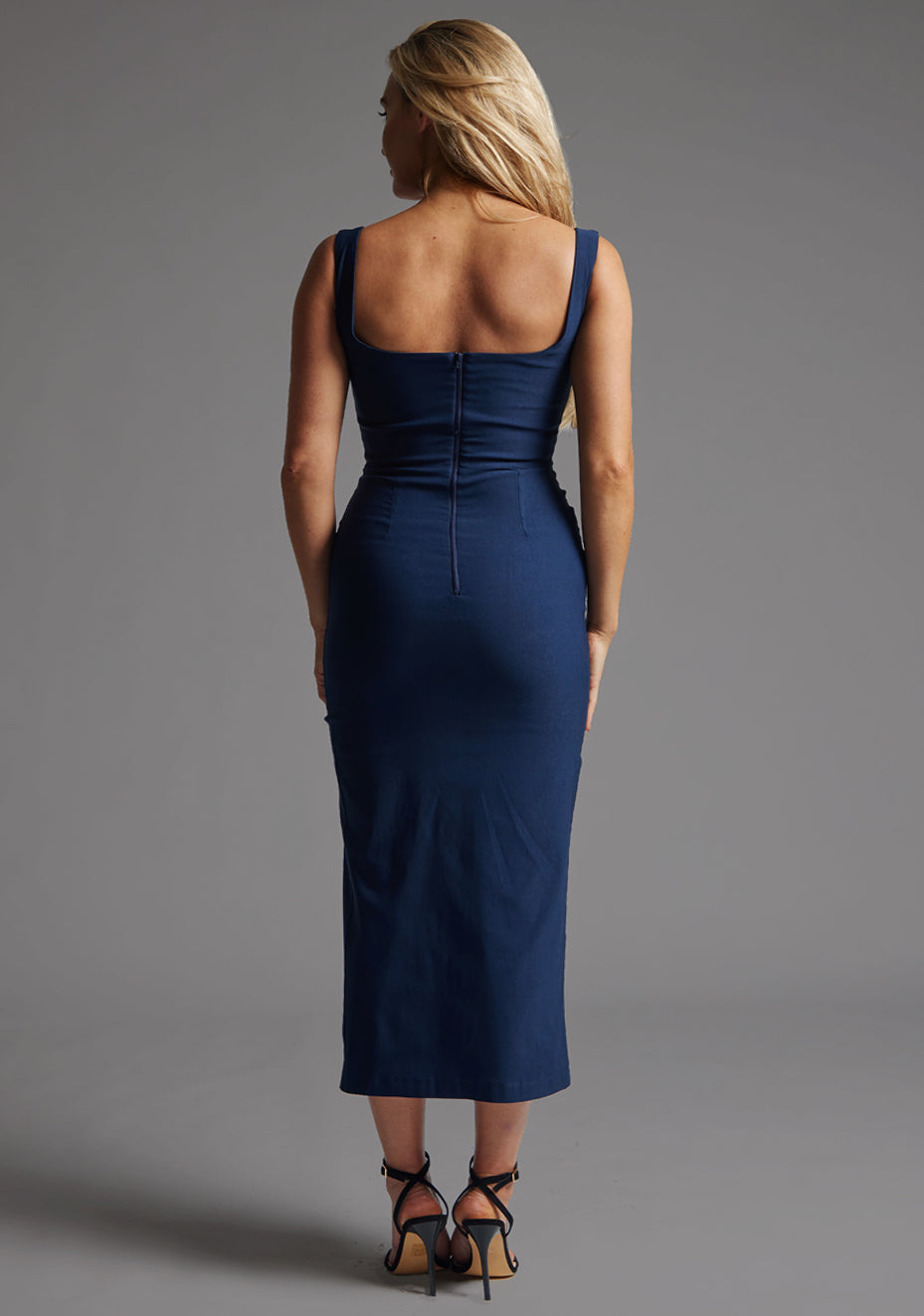 Back image of a model wearing the Vesper Abbie Square Neck Midaxi Dress in Navy with a streamlined fit, structured straps, and refined occasionwear aesthetic.