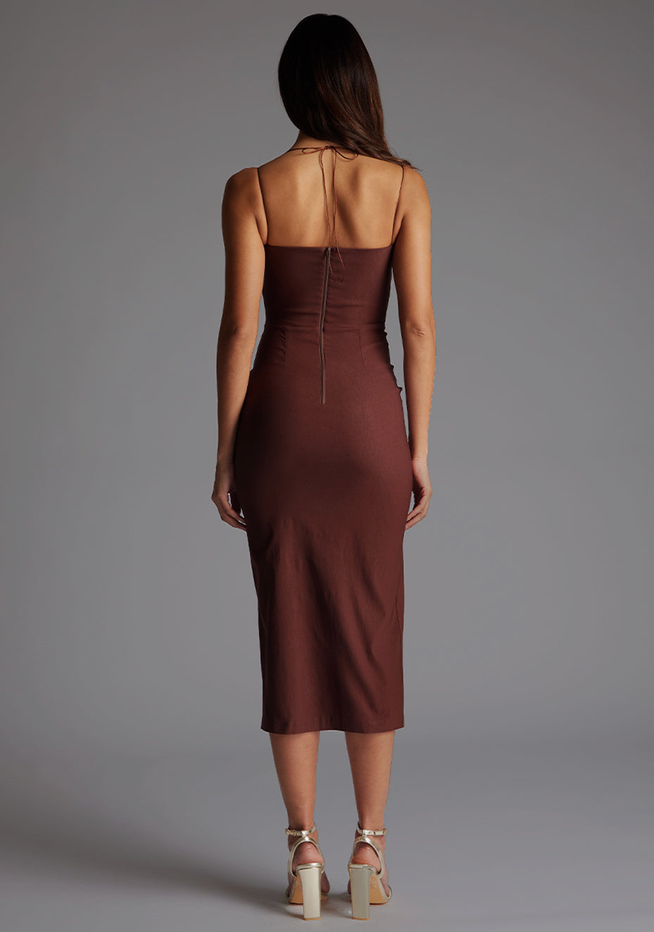 Back image of a model in the Vesper Alyssa Strappy Thigh Split Midaxi Dress in Chocolate, emphasizing the clean minimalist design, refined silhouette, and timeless eveningwear appeal.