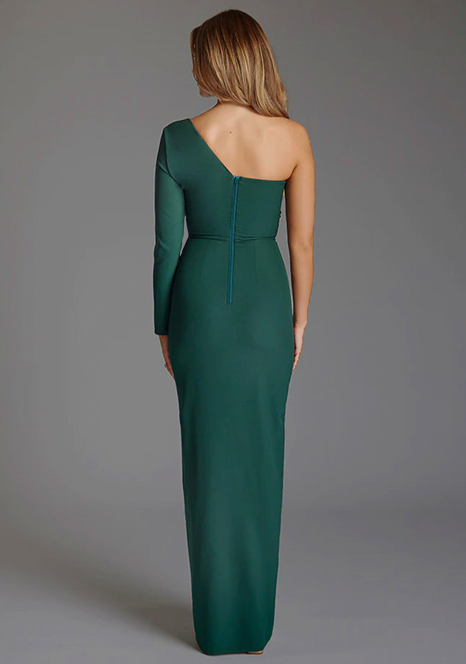 Back image of a model wearing the Vesper Amellia One Sleeve Maxi Dress in Forest Green, emphasizing the clean lines, centre back zip and understated sophistication of the design.