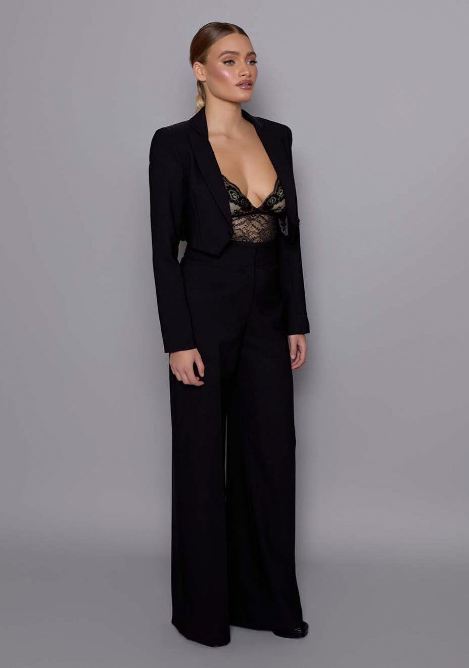 Side-front view of the VSPR Aria cropped tailored jacket showcasing the precise construction, defined waist, and clean cropped hemline.