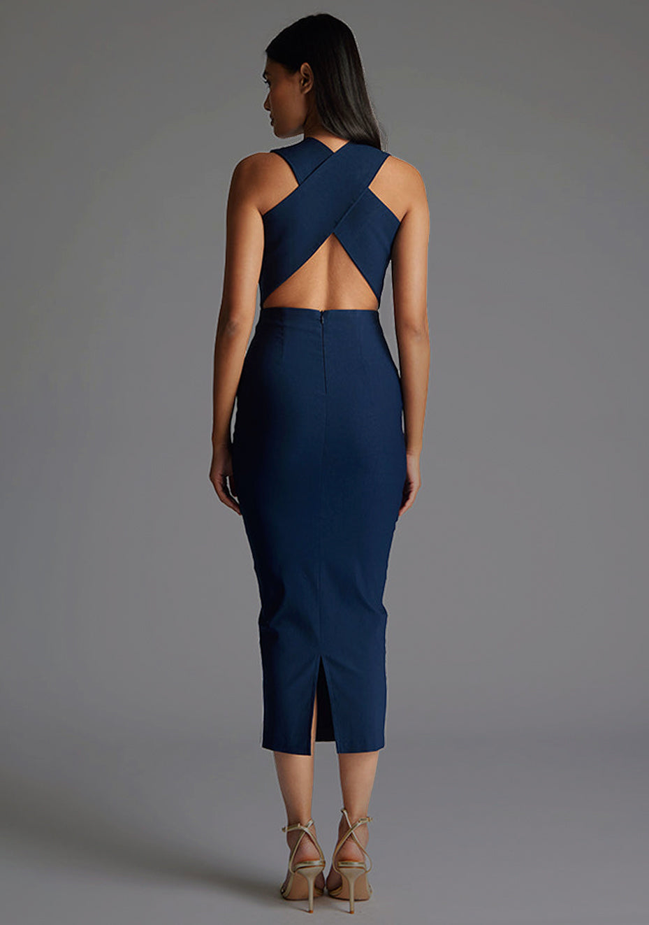 Back view of a model wearing the Vesper Aubrey Plunge Midaxi Dress in Navy featuring a clean, minimal back and sculpted bodycon fit.