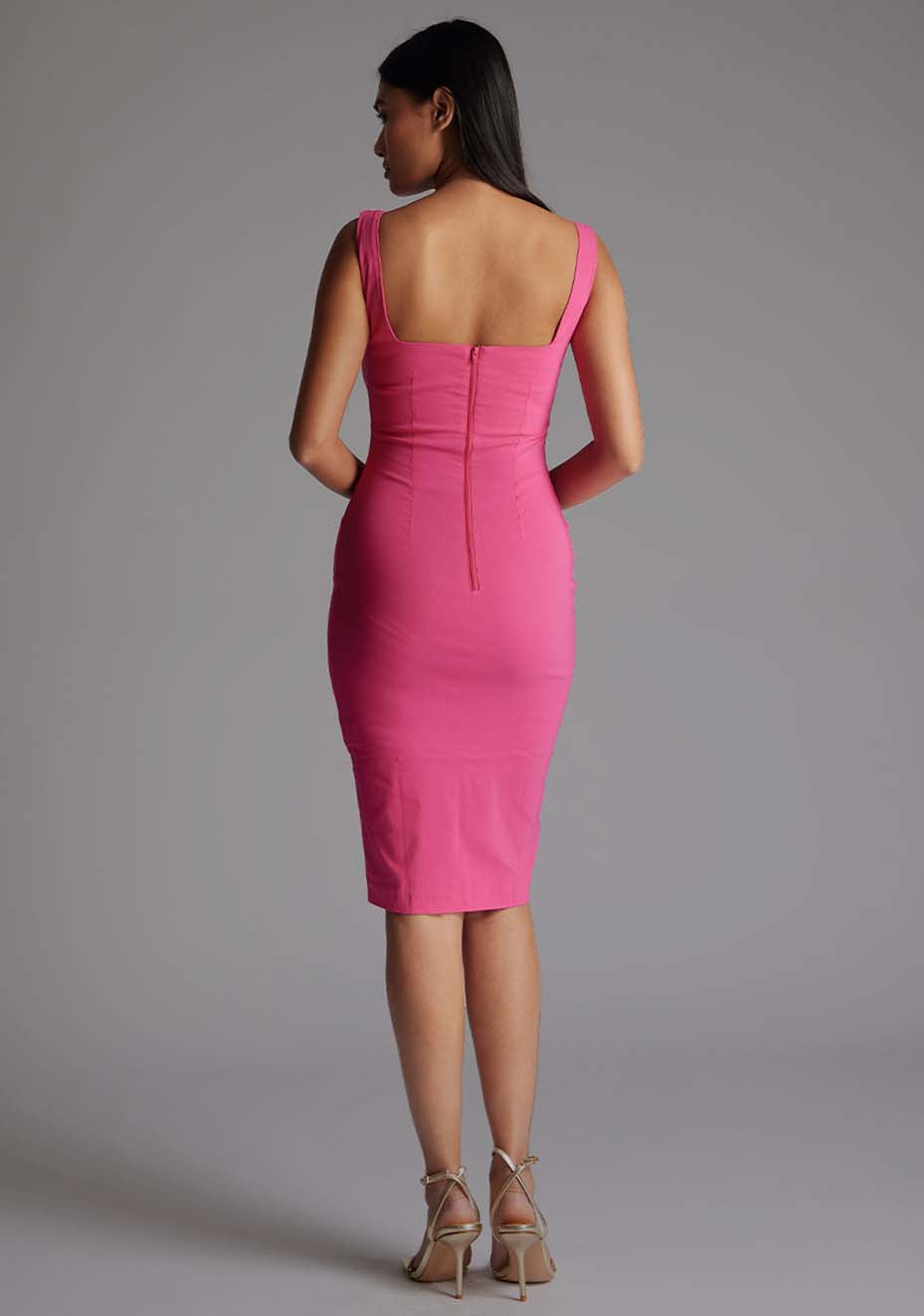 Back image of a model wearing the Vesper Azzura Bodycon Midi Dress in Pink, featuring a center back zip and sleek midi silhouette.