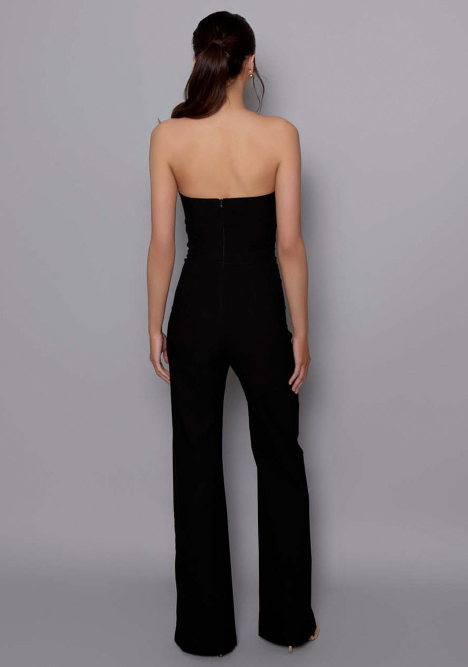Back view of the VSPR Betsy jumpsuit in black, featuring a clean silhouette with invisible centre-back zip and a seamless structured fit.