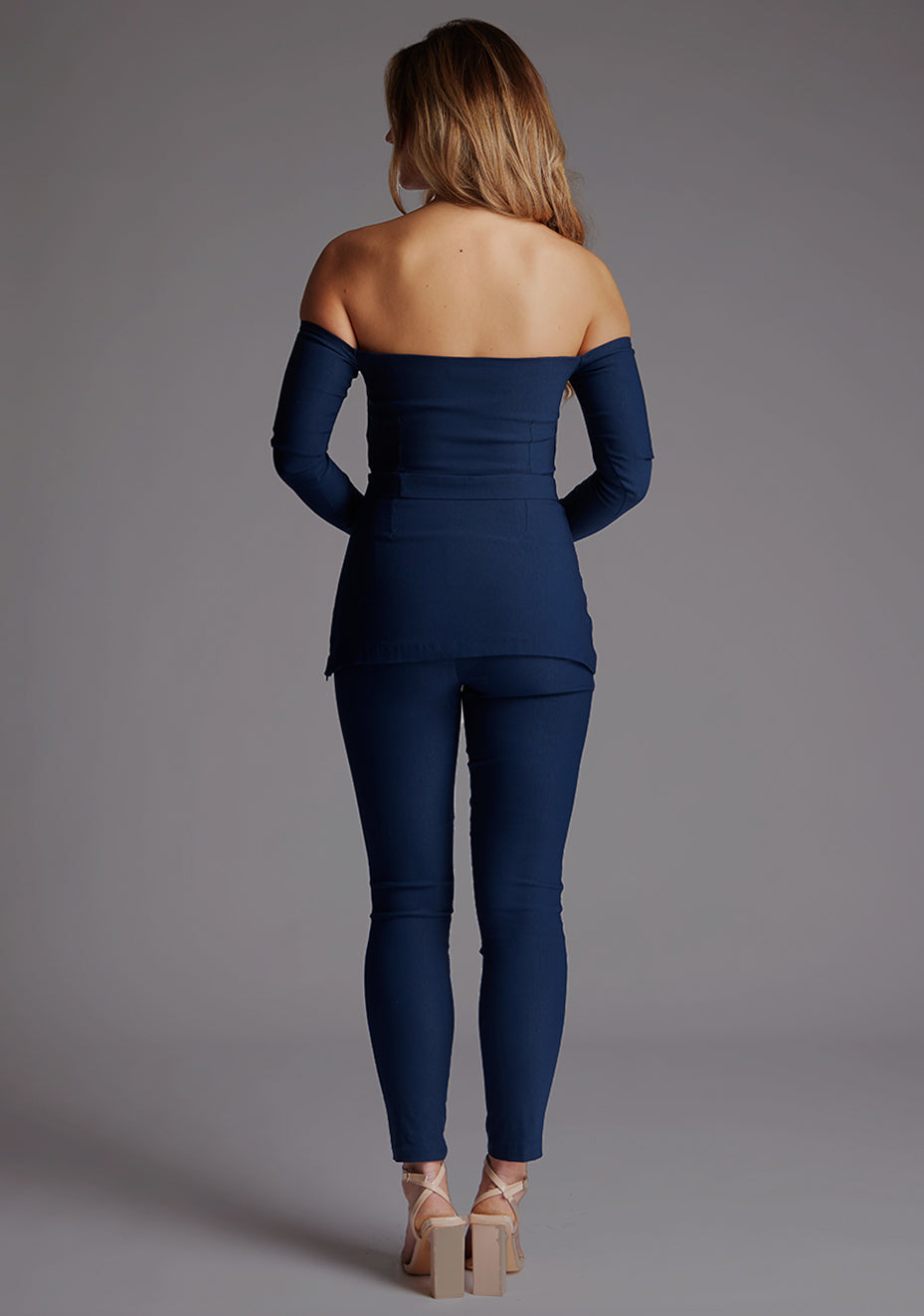 Back image of a model wearing the Vesper Danica Slim Leg Tailored Trousers in Navy, featuring a clean, structured back silhouette and flattering slim-leg cut.