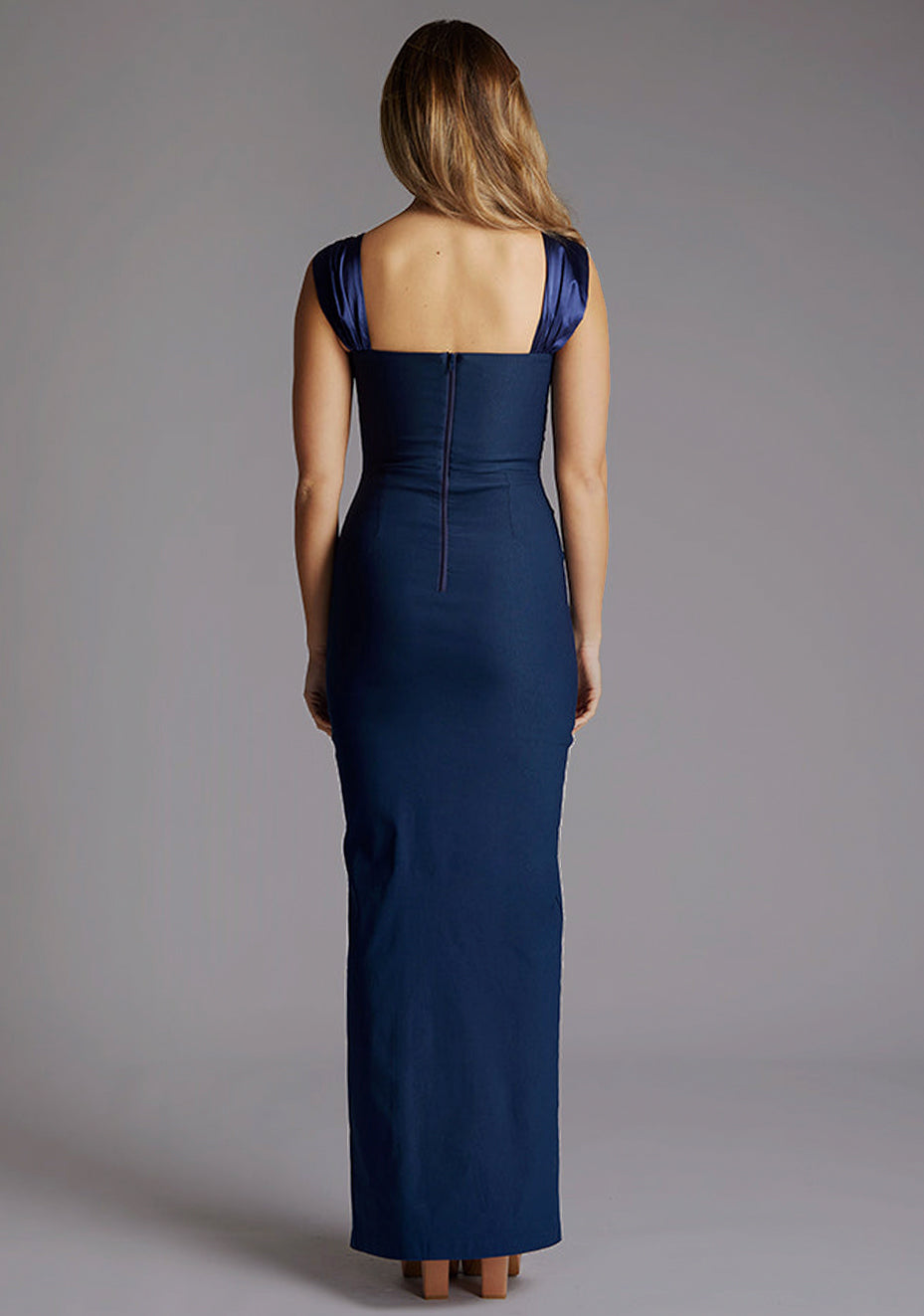 Back image of a model iwearing the Vesper Fame Satin Strap Maxi Dress in Navy, highlighting the clean lines, satin sheen, and timeless maxi-length design.