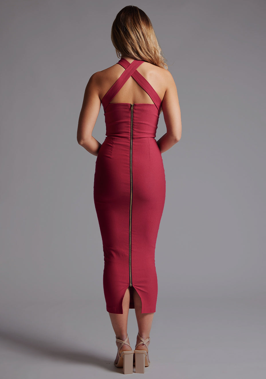 Back image of the Vesper Jemma Halter Neck Midaxi Dress in Raspberry, highlighting the elegant zip detail and polished midaxi finish.