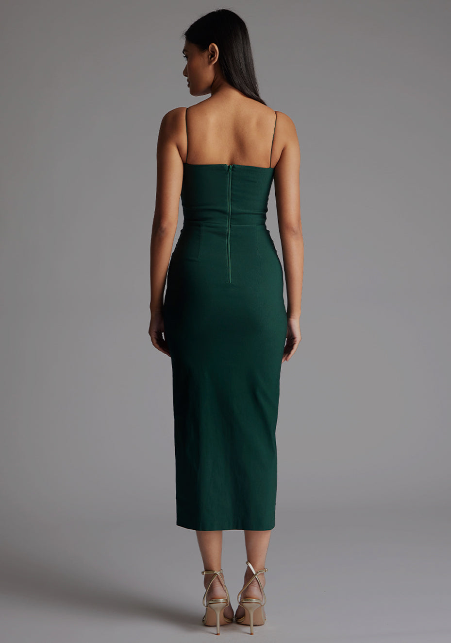 Back image of a model wearing the Vesper Katie Strap Detail Midaxi Dress in Forest Green, displaying a sleek, minimalist back design and flattering midaxi length.