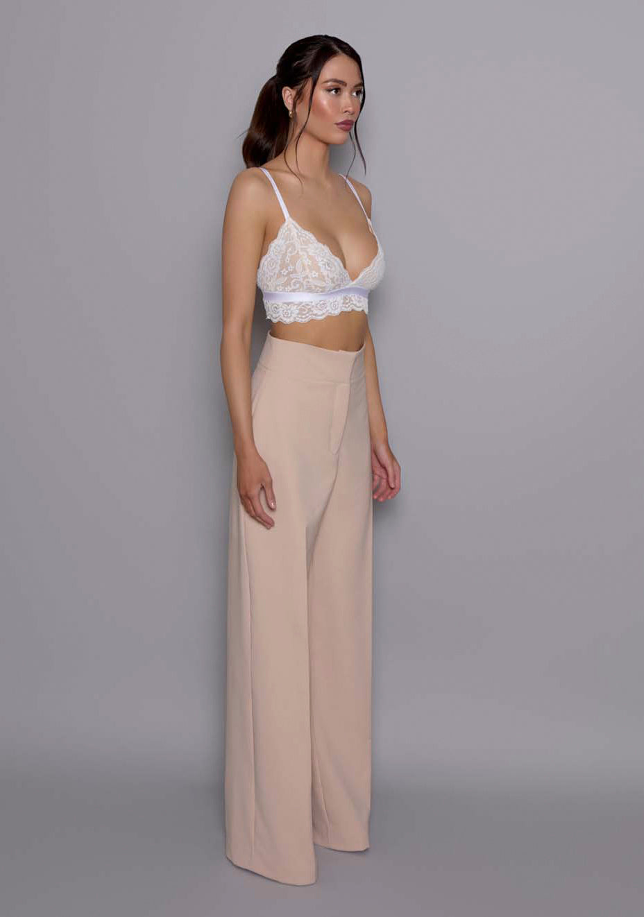 Side front view of the VSPR Lumi High-Waist Tailored Trousers, showing the streamlined wide-leg silhouette and structured high waist, offering a flattering fluid shape.
