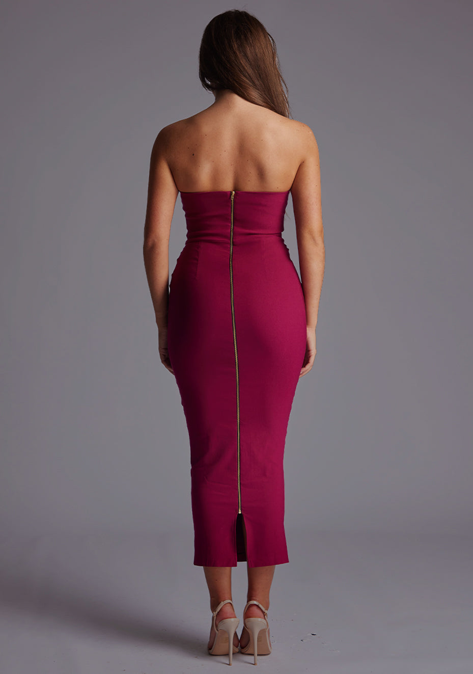 Back image of a model wearing the Vesper Marion Sweetheart Neckline Midaxi Dress in Berry, highlighting the clean back, centre gold back zip and refined bodycon silhouette.