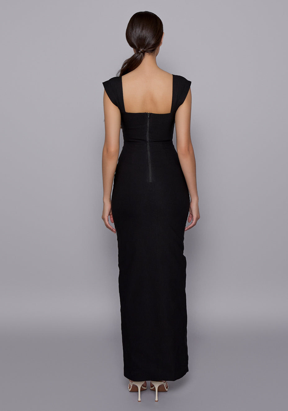 Back view of the VSPR Morgan Black Dress featuring a clean concealed zip, soft cap sleeves, and sleek back seam shaping that enhances the hourglass silhouette.