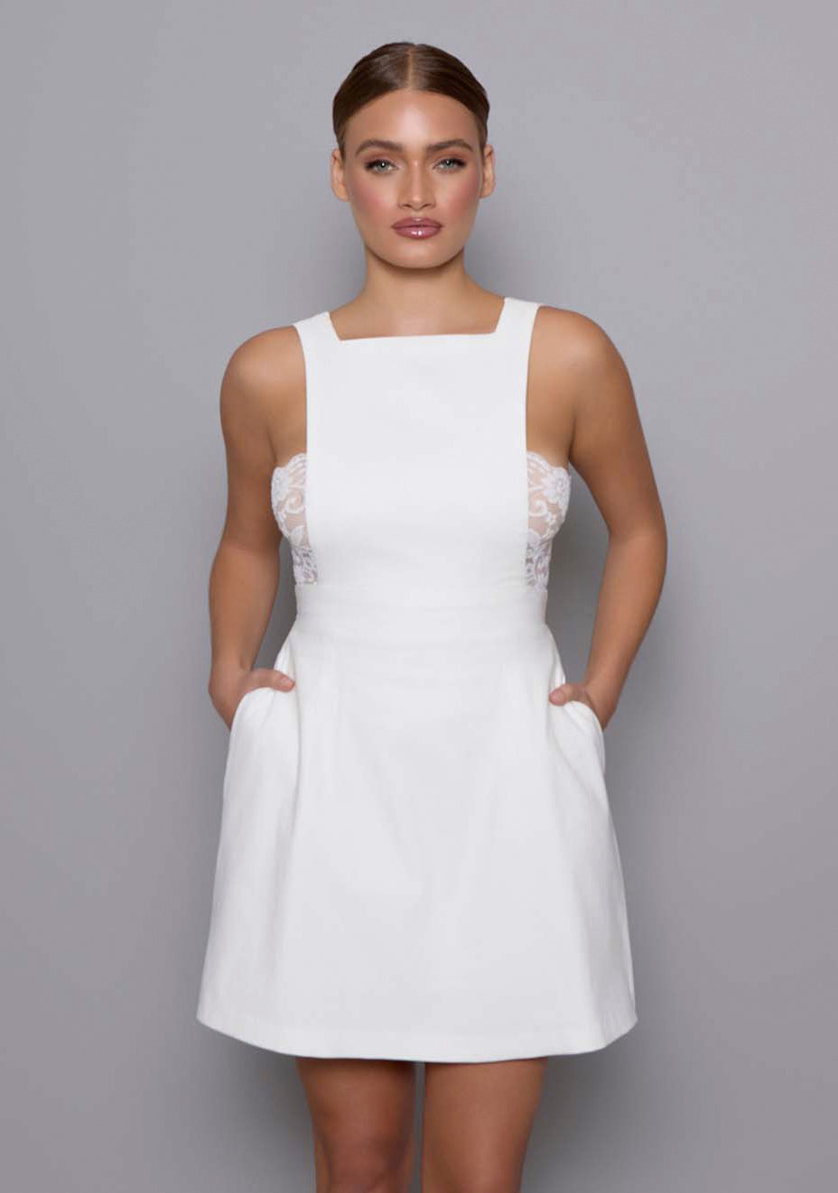 Close-up of the VSPR Noa Open Back Mini Dress showing the fitted bodice, squared neckline, and architectural tailoring, highlighting the fabric texture.