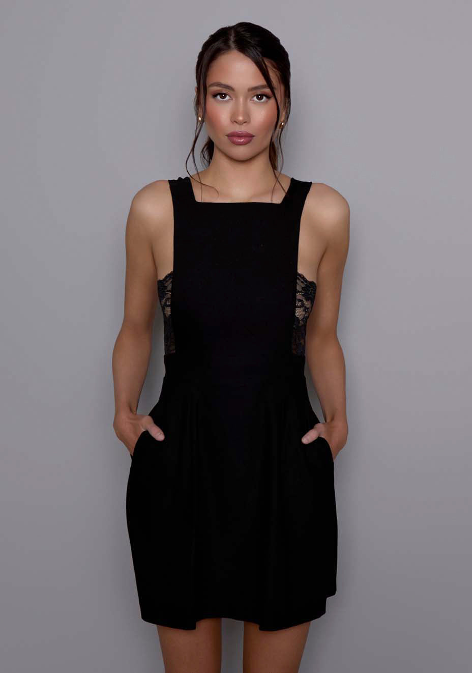 Close-up of the VSPR Noa mini dress highlighting the square neckline, premium stretch-structured fabric, and the contrast between sculpted fit and fluid overlay.