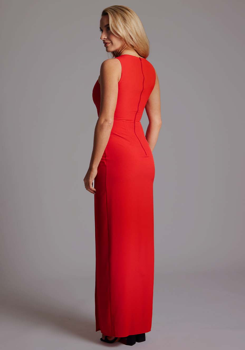 Side back view of a model wearing the VSPR Polly Asymmetrical Maxi Dress in Red, showing the smooth fit and elegant maxi length.