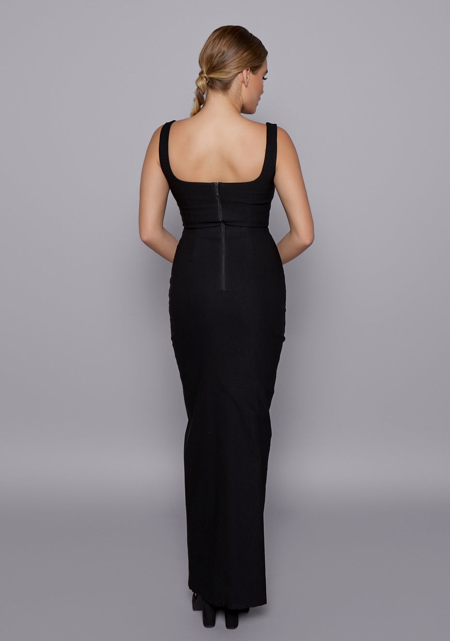 Back view of the VSPR Ria black dress featuring wide straps and a streamlined zip closure, emphasizing the structured back panel and sleek silhouette.