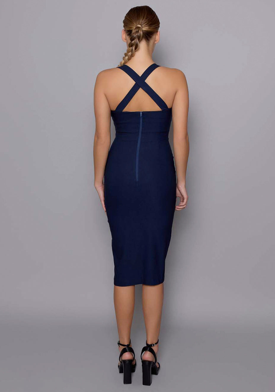 Back view of the VSPR Sian dress in navy, showcasing wide crossover straps, clean zip closure, and the tailored bodycon fit.