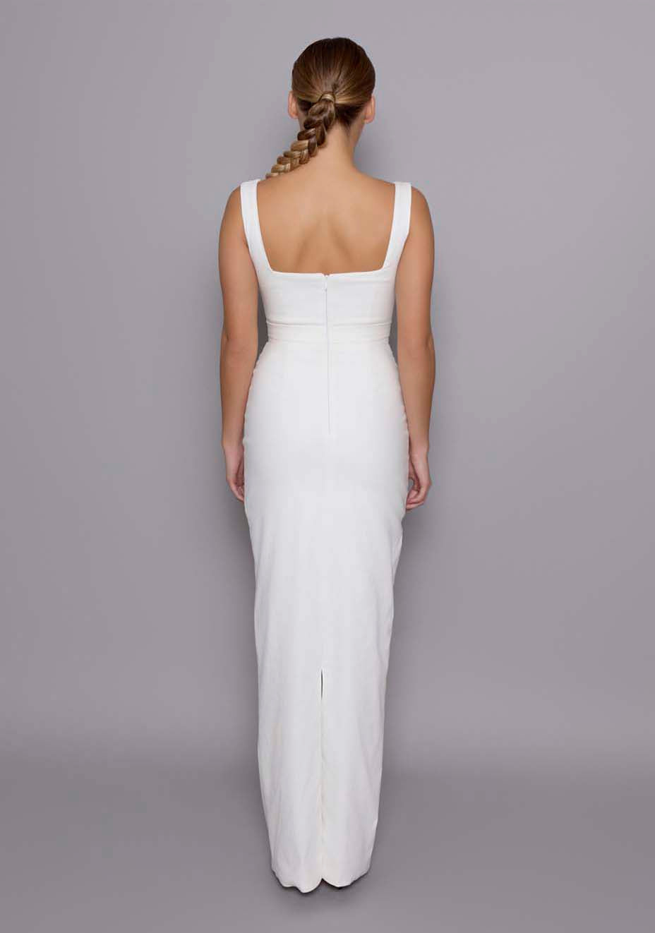 Back view of the VSPR Solene ivory maxi dress showcasing the clean design, wide straps, and the full-length column skirt flowing gracefully, with a glimpse of the dress’s fitted structure.