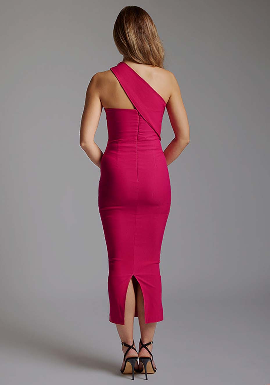 Back image of a model wearing the Vesper Teo One Shoulder Bodycon Midaxi Dress in cerise, featuring a clean back-zip closure and sleek silhouette.