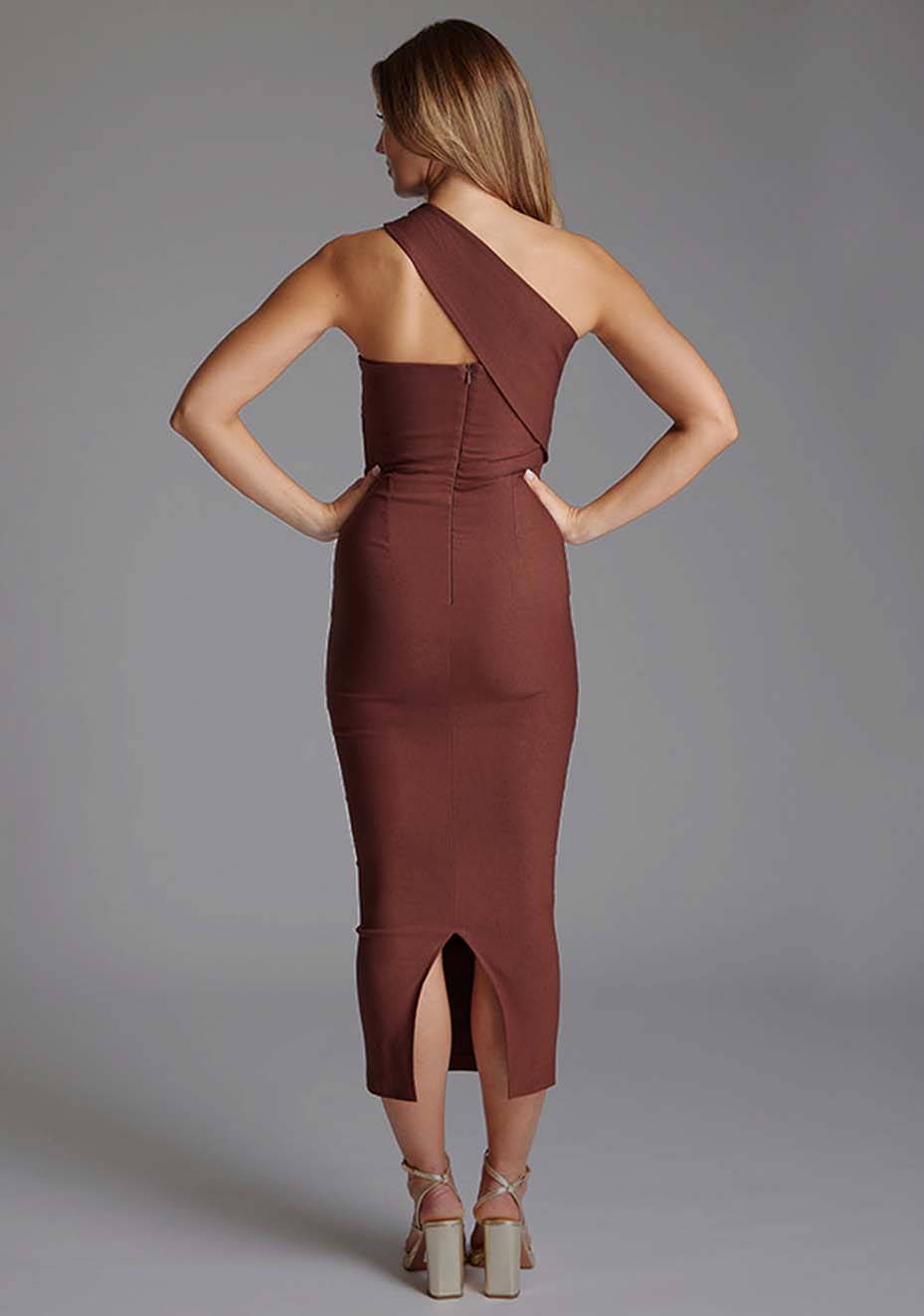 Back image of a model wearing the Vesper Teo One Shoulder Bodycon Midaxi Dress in Chocolate featuring a clean back-zip closure and streamlined silhouette.