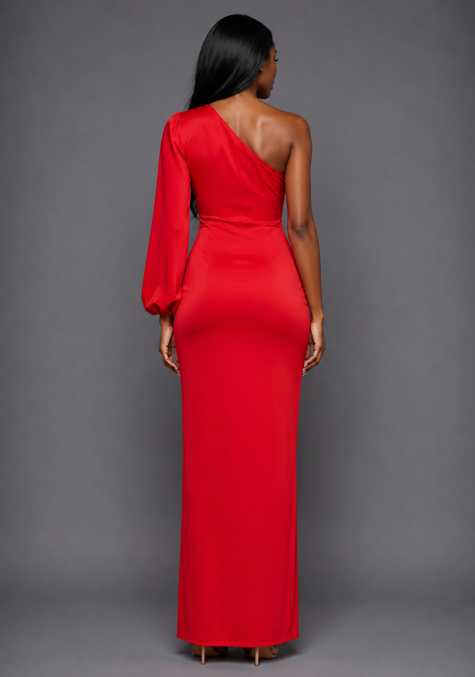 Back image of a model wearing the VSPR Keaton One Sleeve Red Maxi Dress, showcasing its elegant floor-length silhouette and refined drape against a grey studio backdrop.