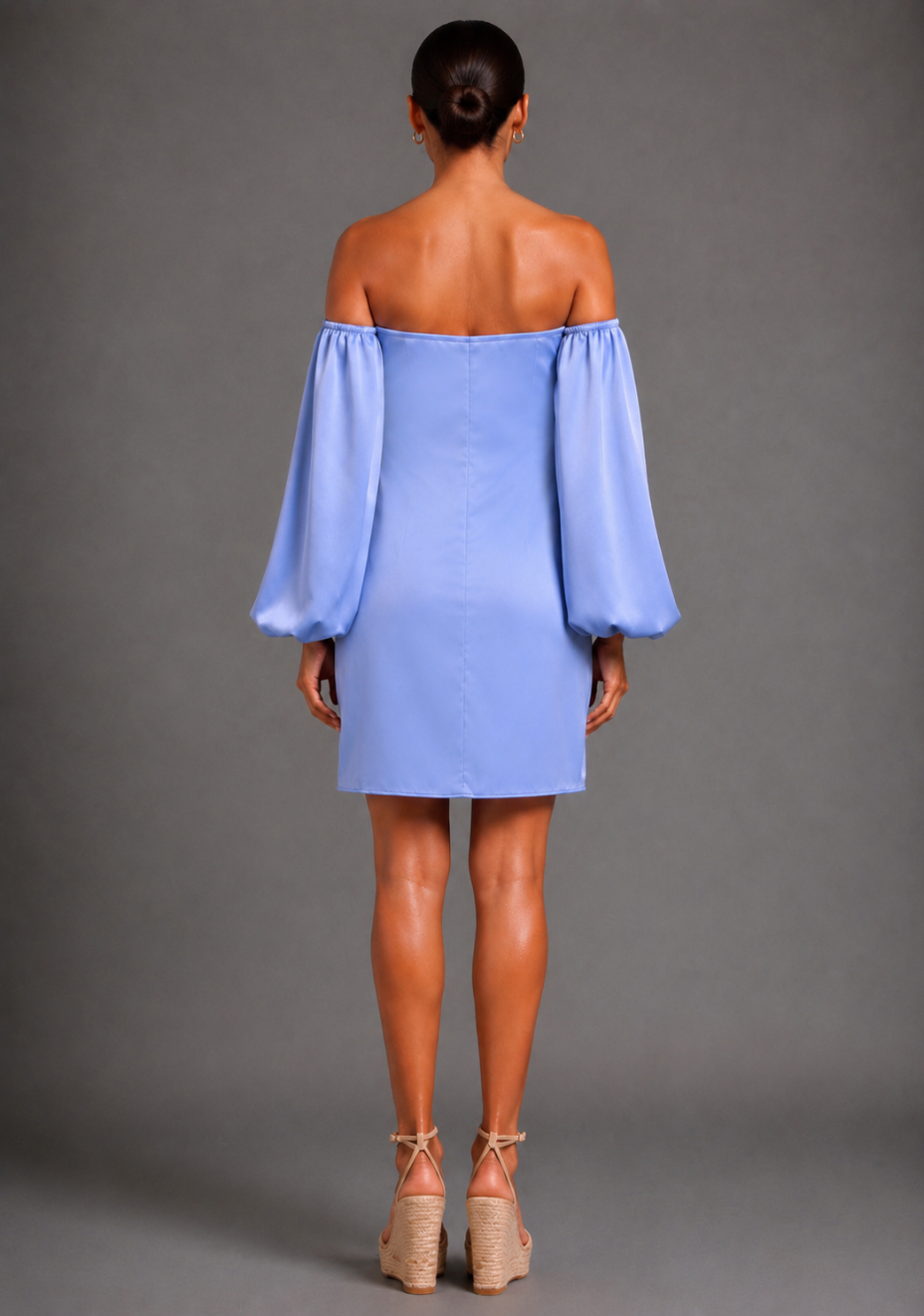 Back view of a model wearing the Vesper Kirby Bardot Long Sleeve Blue Mini Dress highlighting the Bardot neckline and relaxed silhouette.