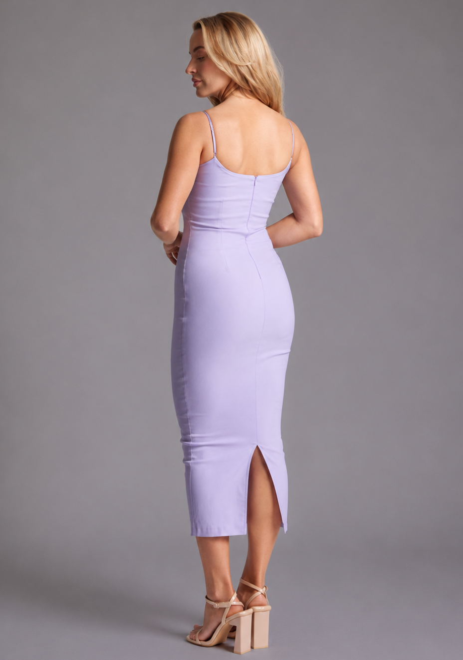 Side-back image of a model wearing the VSPR Maddie Spaghetti Strap Bodycon Midaxi Dress in Lilac, emphasizing its elegant shape, delicate straps, and streamlined midaxi silhouette.