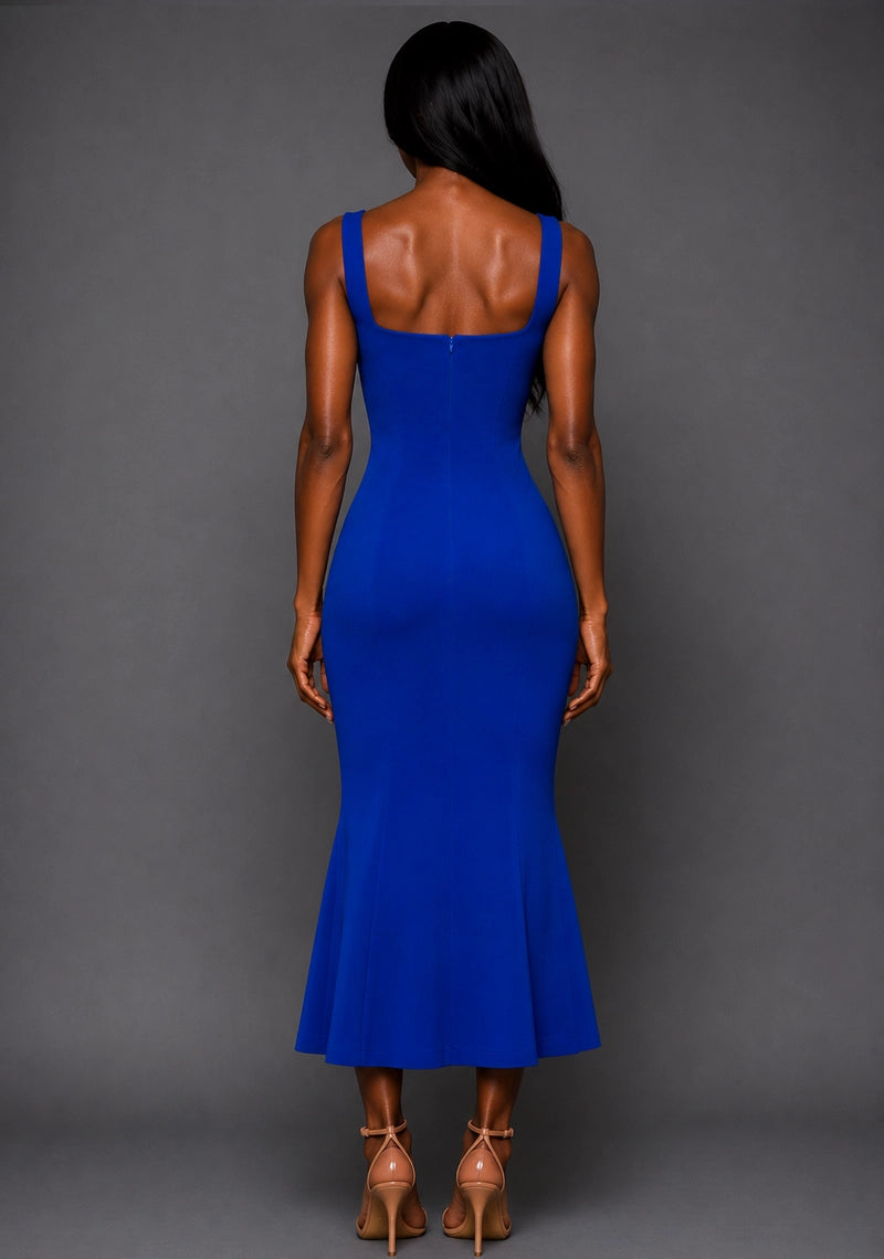 Back image of a model wearing the VSPR Marianna Square Neckline Fishtail Cobalt Midaxi Dress in Cobalt Blue from the back, highlighting the sleek silhouette, structured design, and midaxi length against a grey studio backdrop.