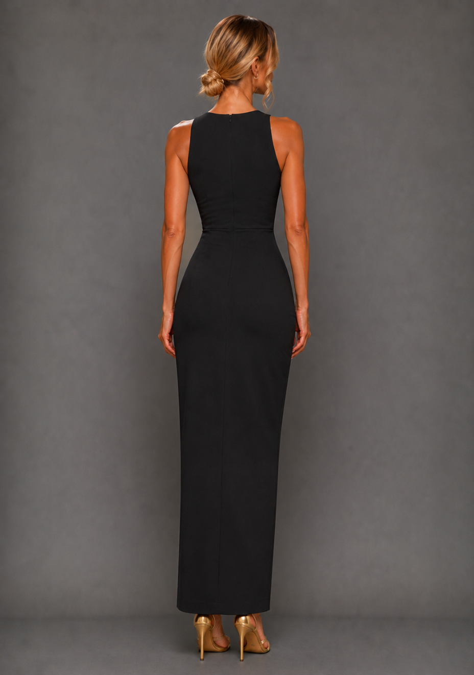 Back image of a model wearing the VSPR Polly Asymmetrical Maxi Dress in Black featuring a clean centre-back zip and flowing maxi silhouette.