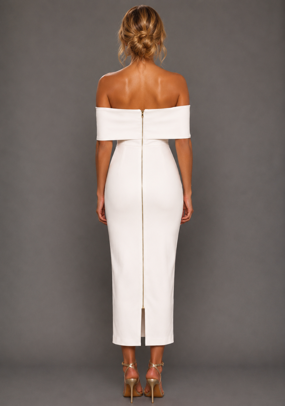 Back image of a model wearing the VSPR Sarah Bardot Midaxi Dress in Ivory, showcasing the clean back finish, gold zip detail and sculpted silhouette against a grey studio backdrop.