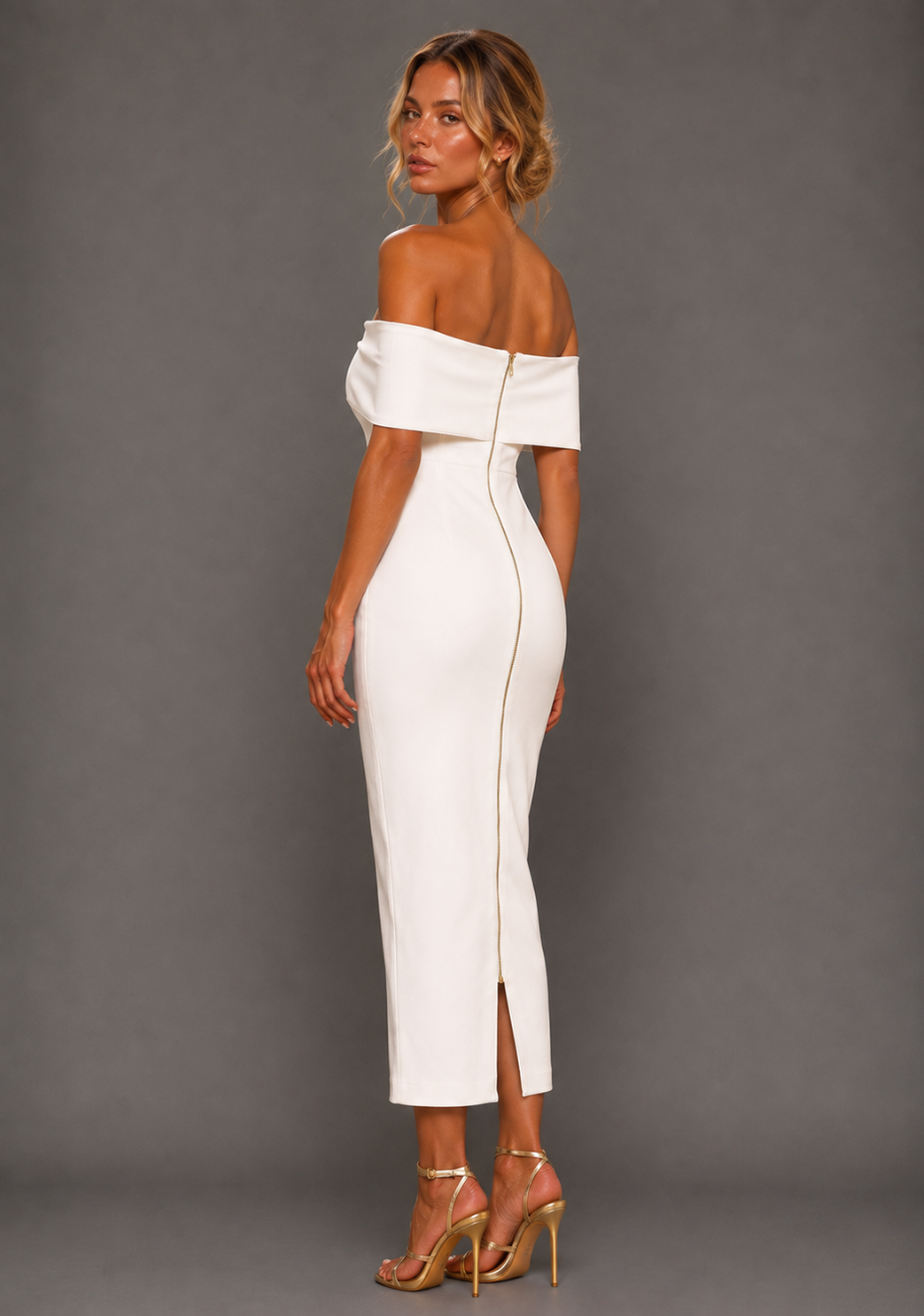 Side back image of a model wearing the VSPR Sarah Bardot Bodycon Ivory Midaxi Dress, showcasing the sleek fitted silhouette and elegant midaxi length against a grey studio backdrop