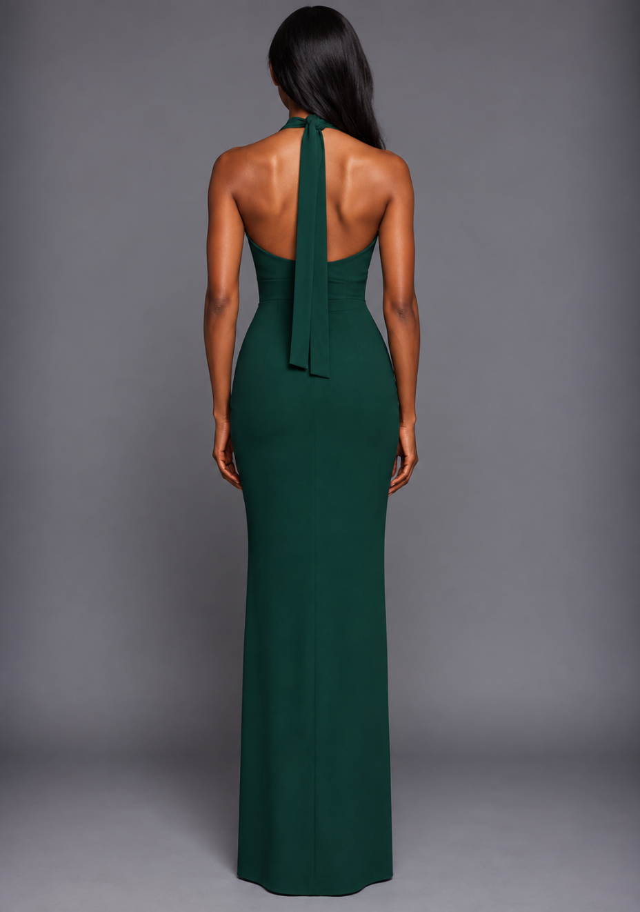 Back image of a model wearing the VSPR Sedona Halterneck Maxi Dress in Forest Green, showcasing the elegant halterneck design and sleek maxi-length silhouette against a grey studio backdrop.