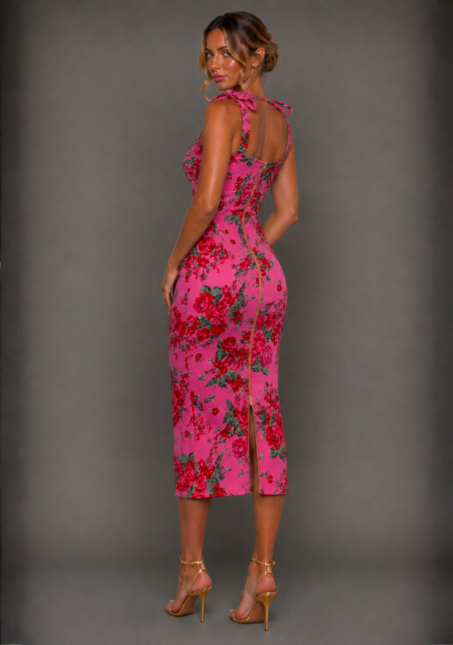 Side back image view of a model wearing the Vesper Soraya Bodycon Tie Strap Pink Floral Midaxi Dress displaying the body-contouring fit and floral print.