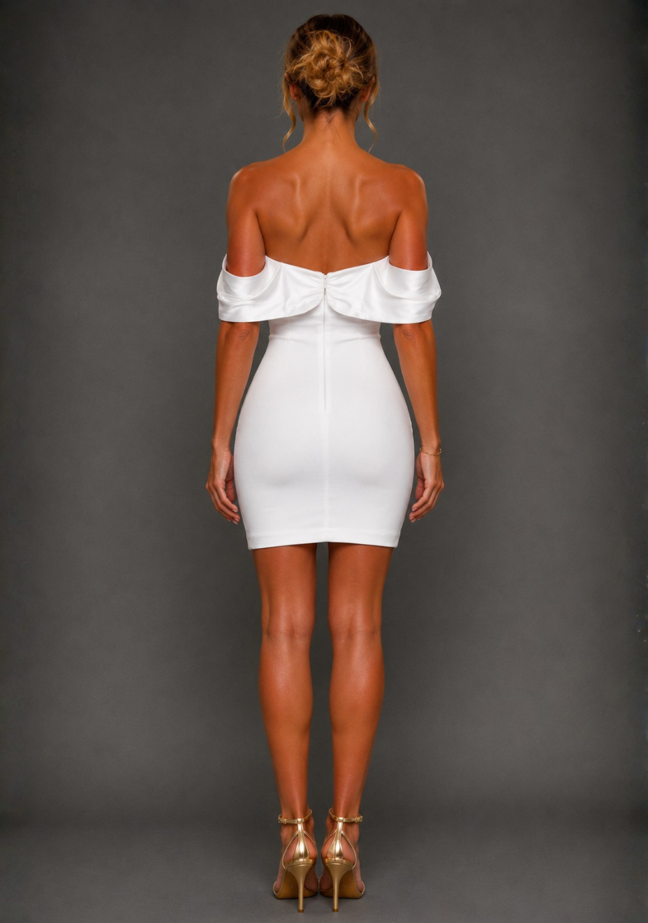Back view of a model wearing the Vesper Paloma Bardot Satin Sleeve Ivory Mini Dress highlighting the Bardot neckline, satin sleeves and fitted silhouette.