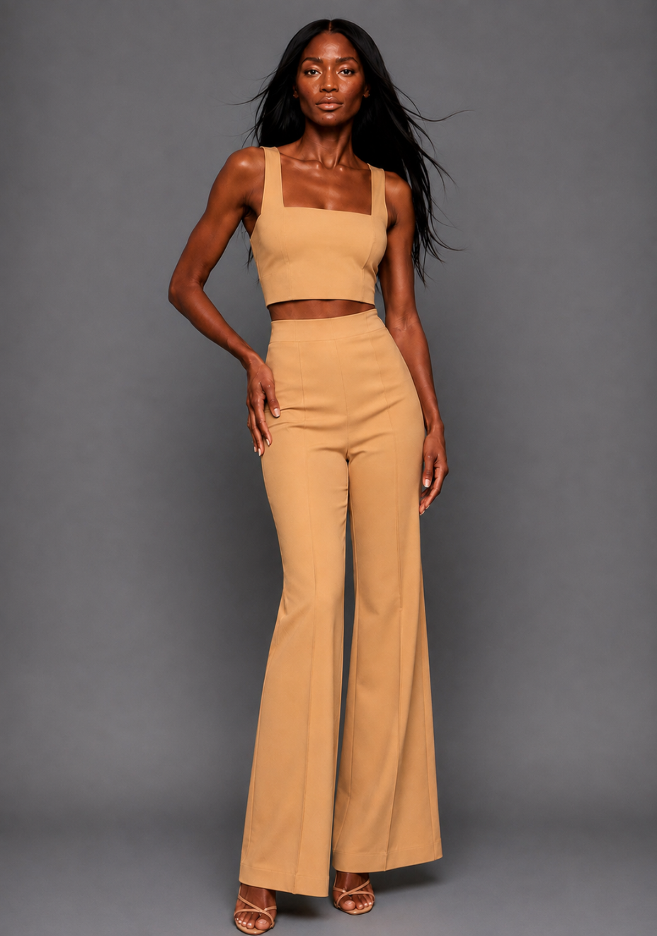 Front image of a model wearing the VSPR Mia Square Neck Coffee Crop Top and matching VSPR Shea Coffee Wide Leg Trousers, showing the square neckline and high-rise wide-leg silhouette, standing against a grey studio backdrop.