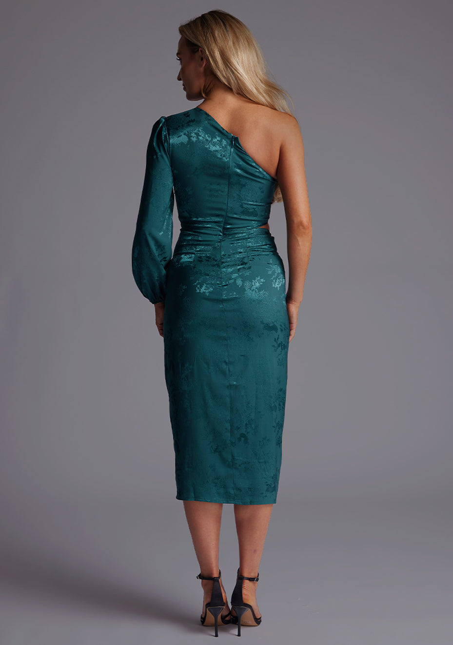 Back image of a model wearing the Vesper Alice One Sleeve Midi Dress in Pine Green featuring an invisible zip closure and sleek, streamlined silhouette.