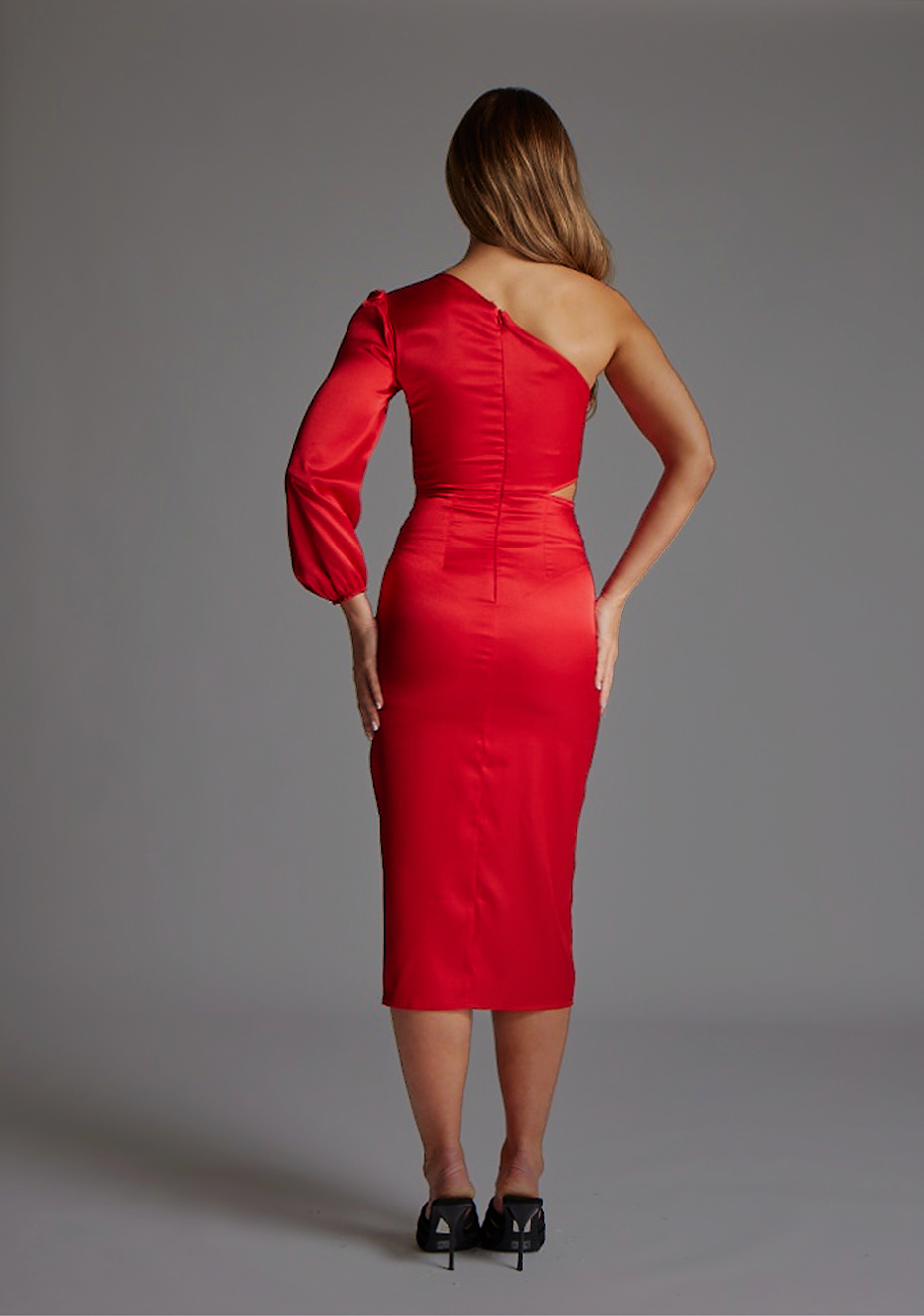 Back image of a model wearing the Vesper Alice One-Sleeve Midi Dress in Red, featuring a clean satin finish, polished midi length, and concealed invisible back zip for seamless wear.