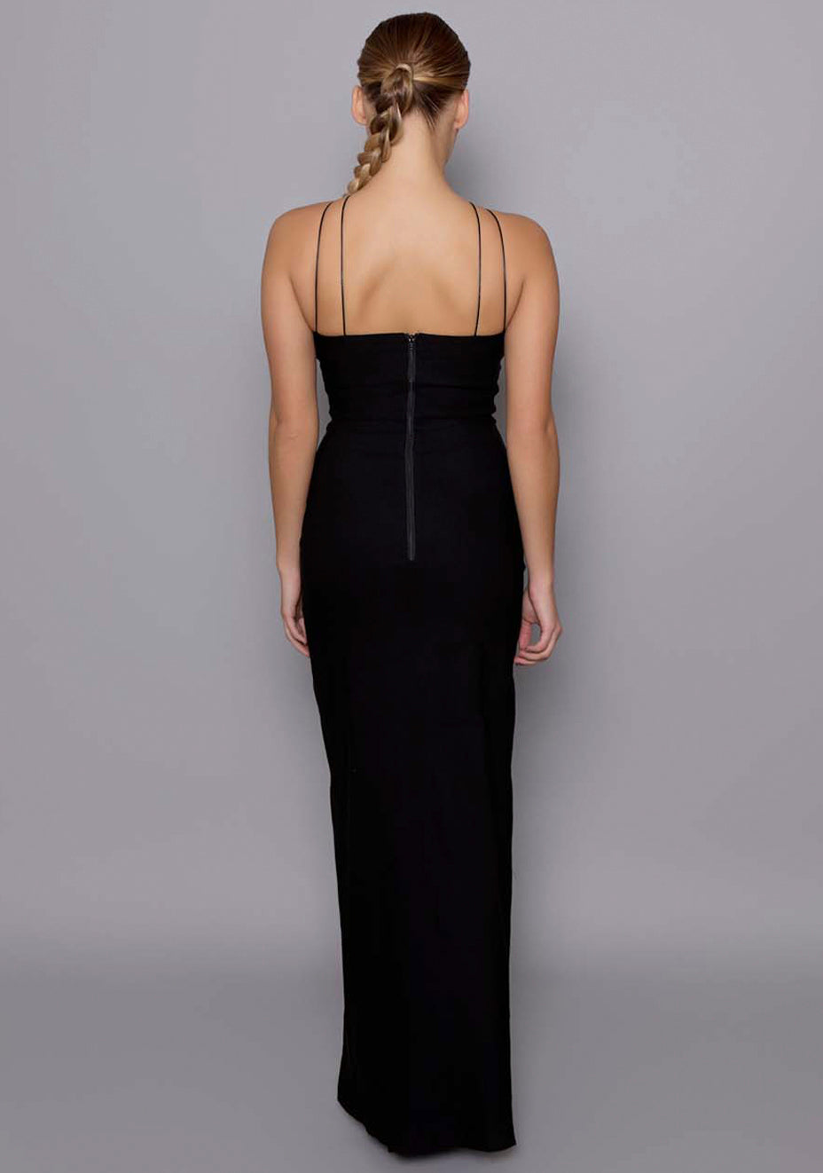 Back view of the VSPR Auralia dress revealing the sleek double-thin straps, clean zip closure, and sculpted silhouette flowing into a maxi-length hem.