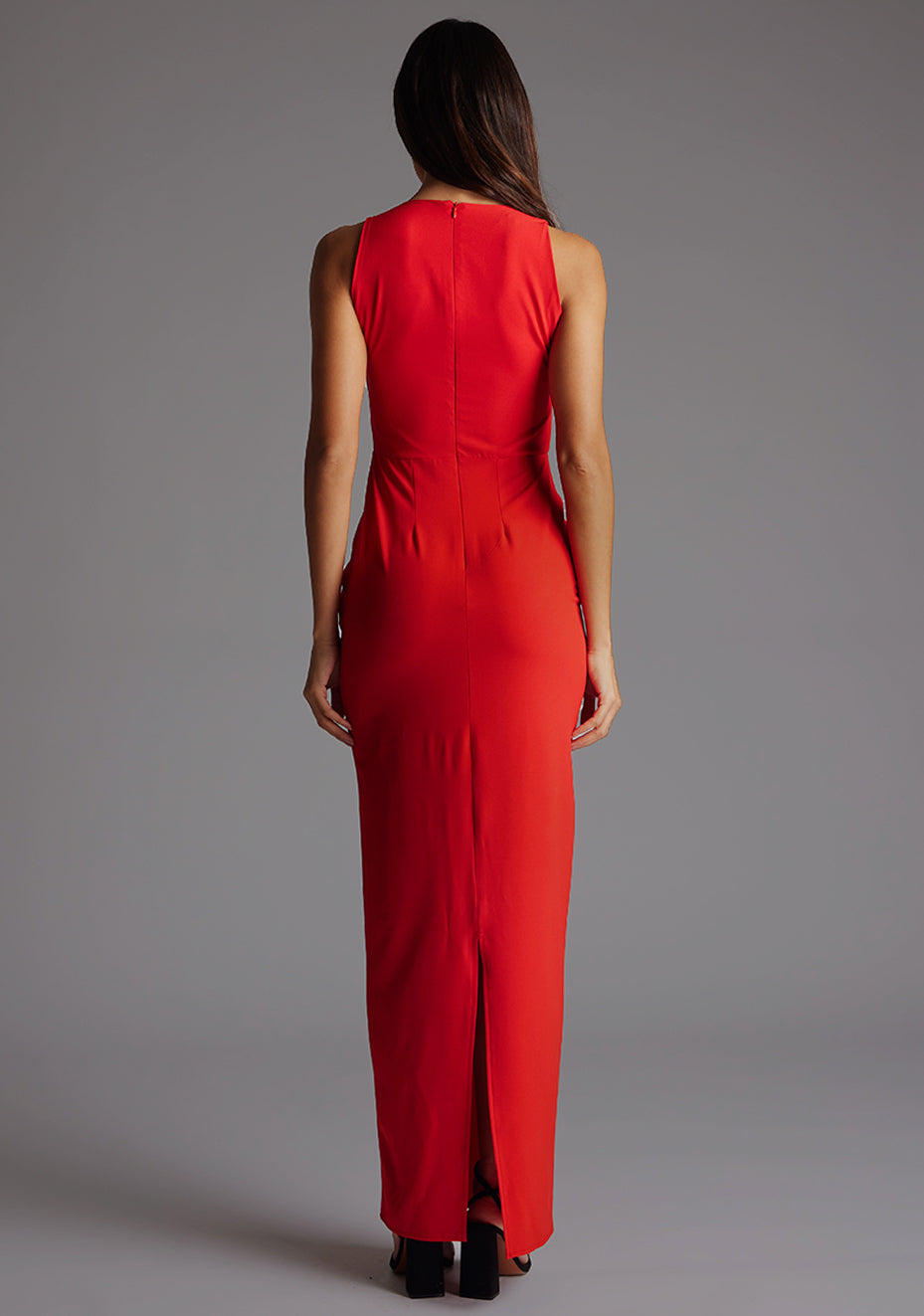 Back image of a model wearing the Vesper Azalea V-Neckline Maxi Dress in Red showing the streamlined back and floor-length design.