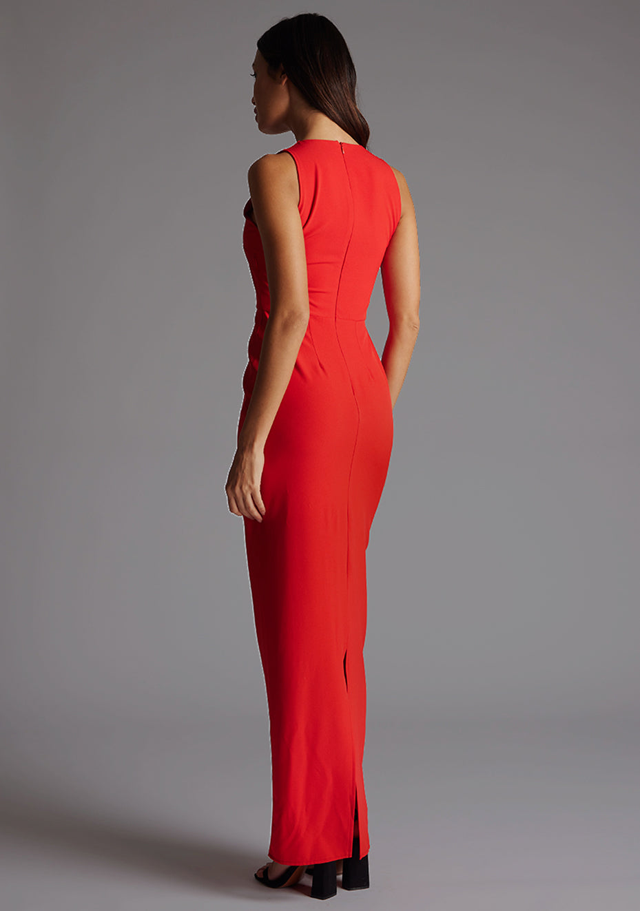 Side back image of a model wearing the Vesper Azalea V-Neckline Maxi Dress in Red revealing the sleek lines and smooth rear fit.