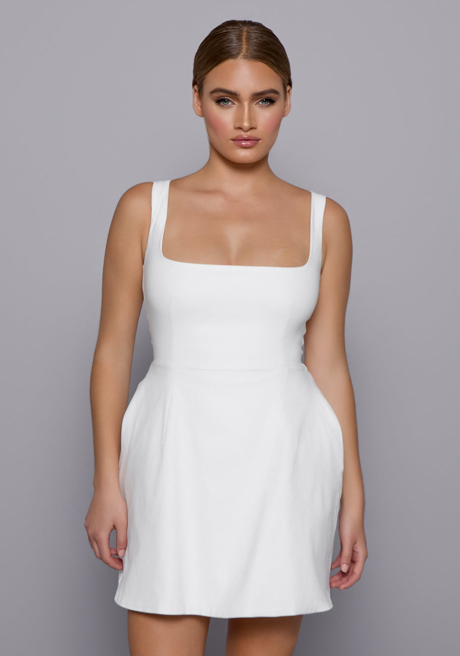lose-up of the VSPR Camille Dress highlighting the square neckline, smooth stretch fabric, and refined seam detailing for a structured, polished look.