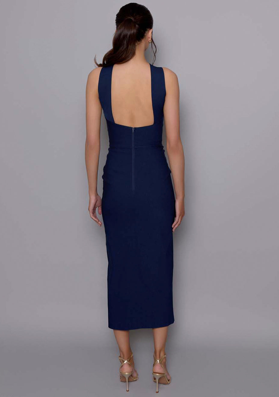 Back view of the VSPR Carter dress with squared open-back and clean seam detailing, revealing the sleek silhouette and midaxi length.
