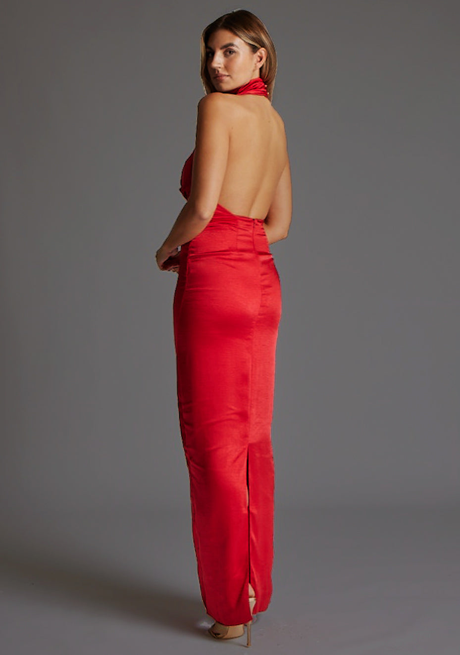 Side back image of a model wearing the Vesper Colby Cowl Neck Open Back Satin Maxi Dress in Red, revealing the open-back detail and sleek satin finish.