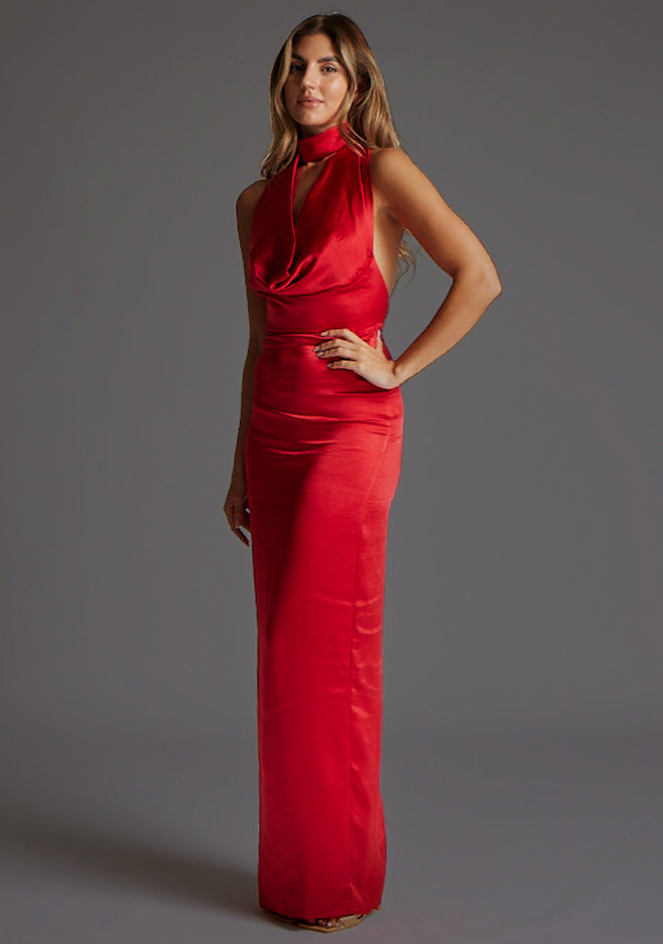 Side front view of the Vesper Colby Satin Maxi Dress in Red, emphasizing the sleeveless cut, liquid satin movement, and elegant maxi length.