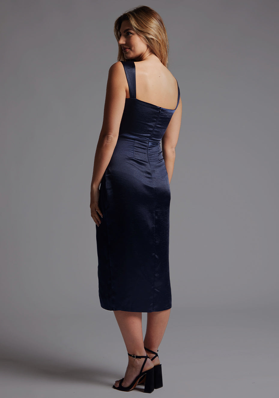 Side back view of the Vesper Desiree Sweetheart Neckline Midaxi Dress in Navy, showcasing the clean lines and refined structure through the back and hips.
