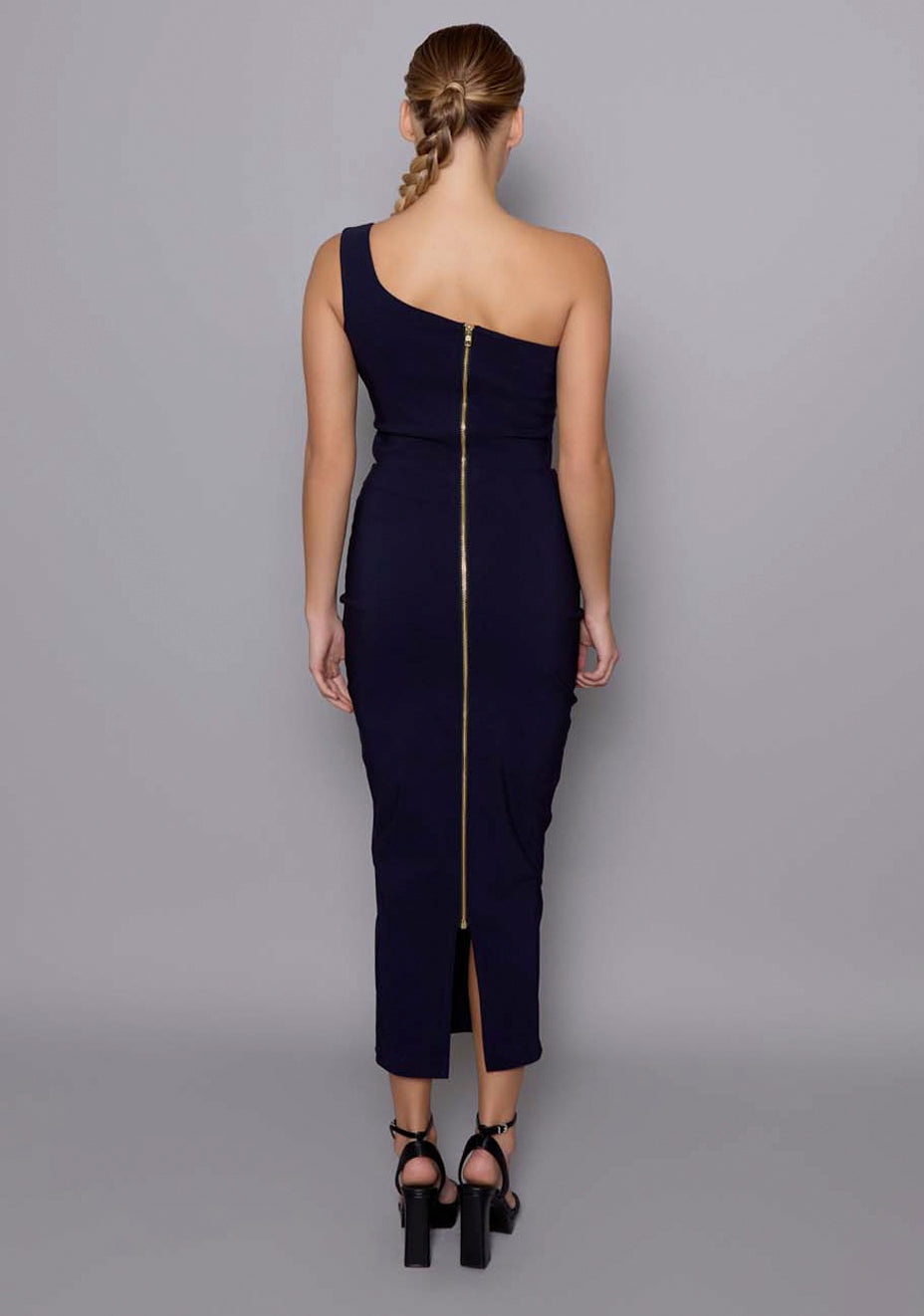 Back view of the VSPR Eliza midaxi dress featuring a full-length exposed gold zip, showcasing the body-contouring fit and modern clean lines.